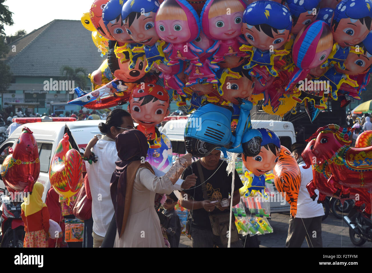Surabaya, Indonesia - September 24, 2015: Merchants sell a toy children to welcome muslims are celebrating Eid al-Adha in Al Akbar mosque in Surabaya, East Java, Indonesia, September 24, 2015. Indonesia, which is a country with the largest Muslim population in the world, celebrate Eid al-Adha by praying and slaughtering cow or goat to commemorate The Prophet Ibrahim's willingness to sacrificed his son in order to fulfill a demand from Allah Credit:  dodo hawe/Alamy Live News Stock Photo