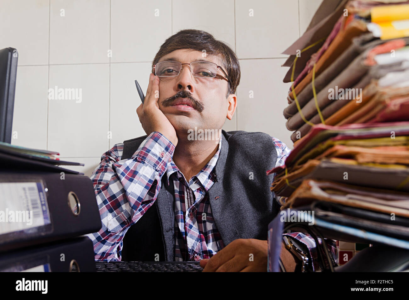 Indian man thinking holding pen hi-res stock photography and images - Alamy