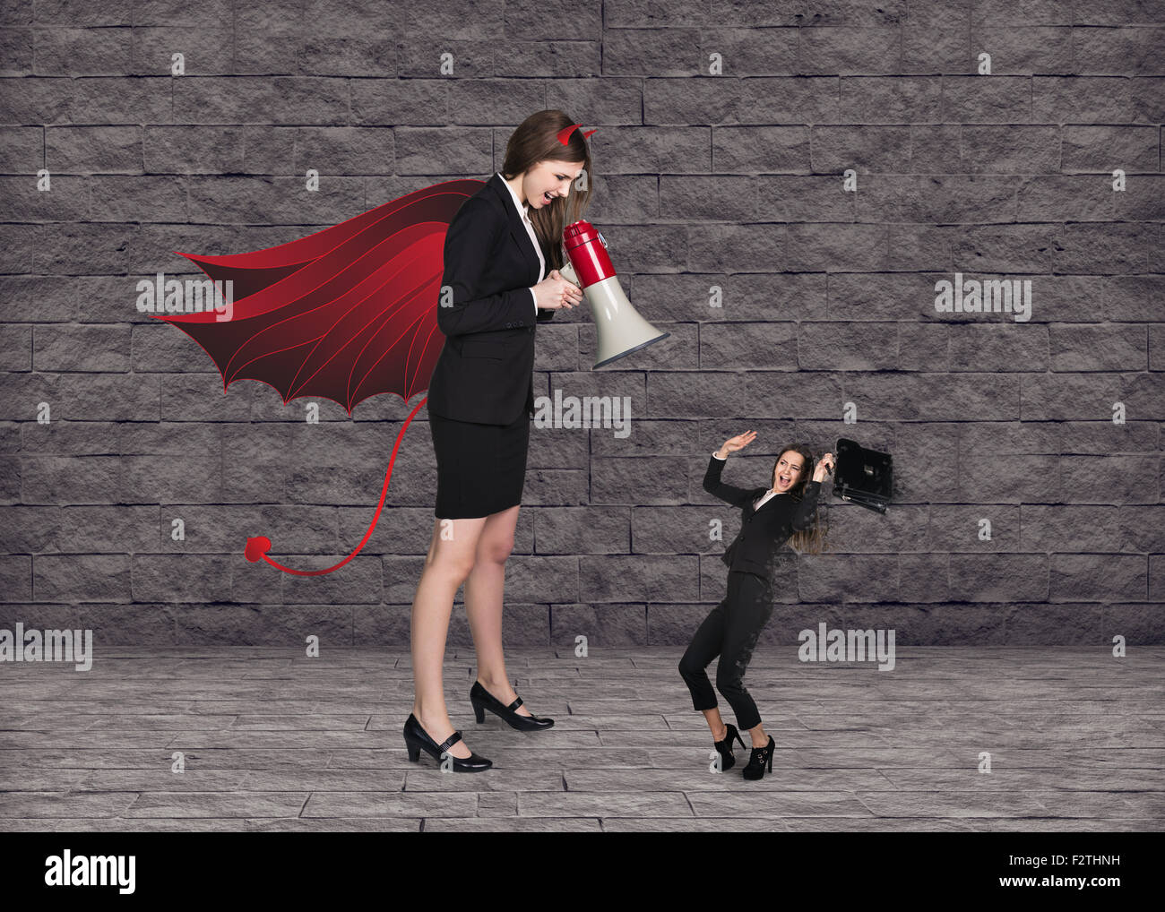 Devil businesslady with a megaphone screeming Stock Photo