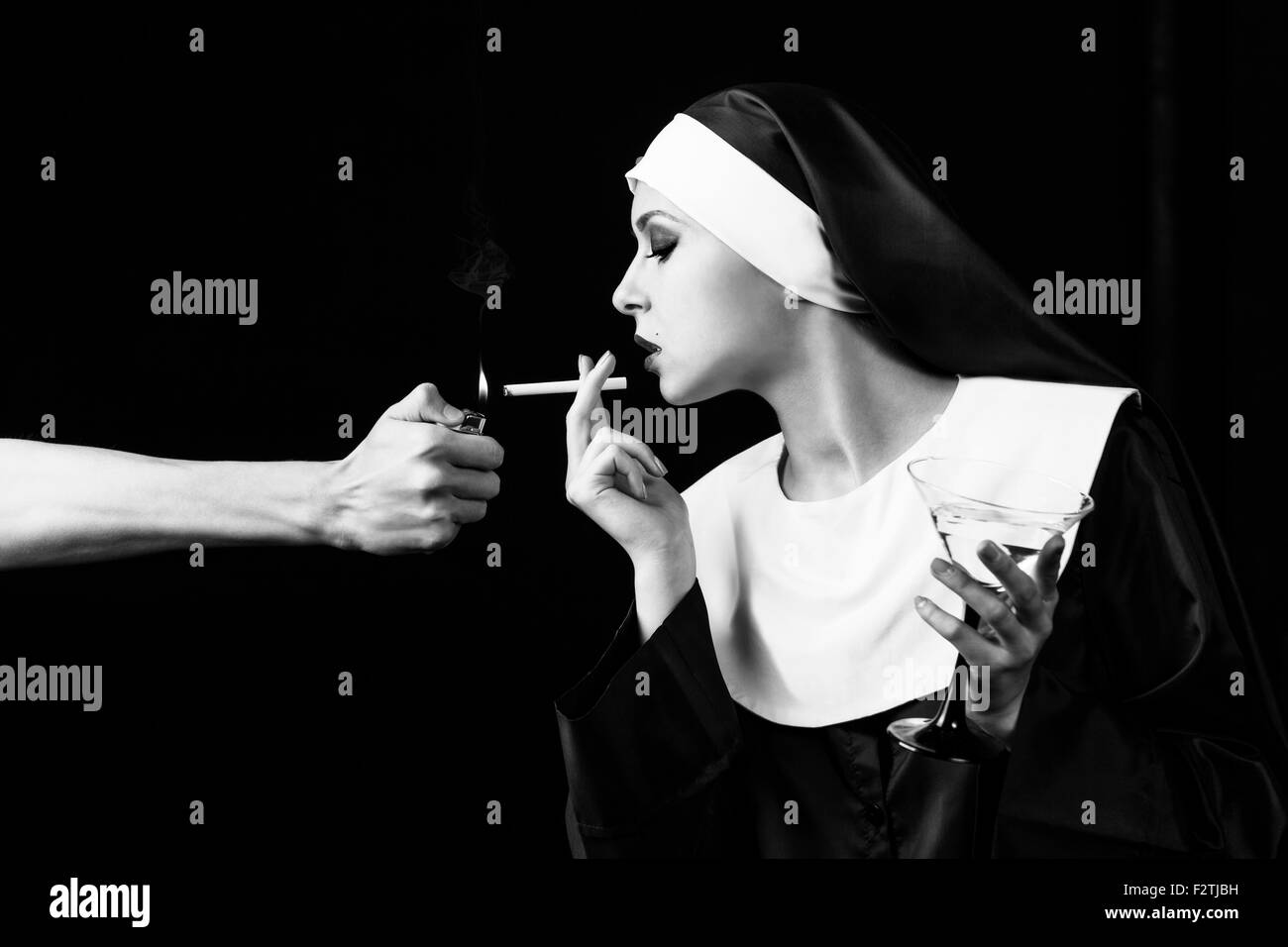 Smoking young nun Stock Photo