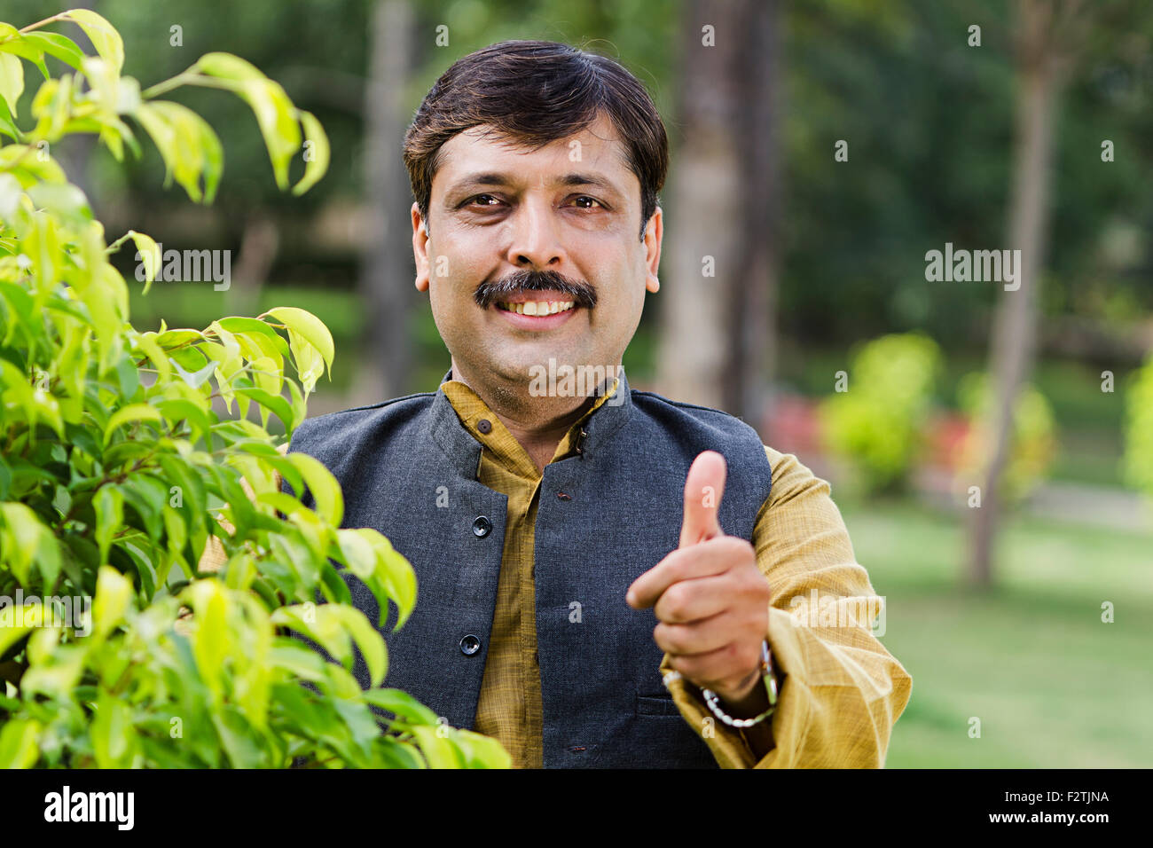 1 indian Adult Man standing Garden Thumbs Up Showing Stock Photo