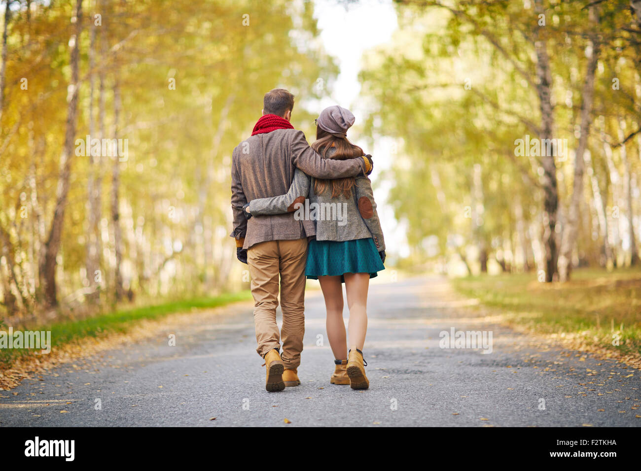 Back view of young couple walking in park in autumn Stock Photo - Alamy