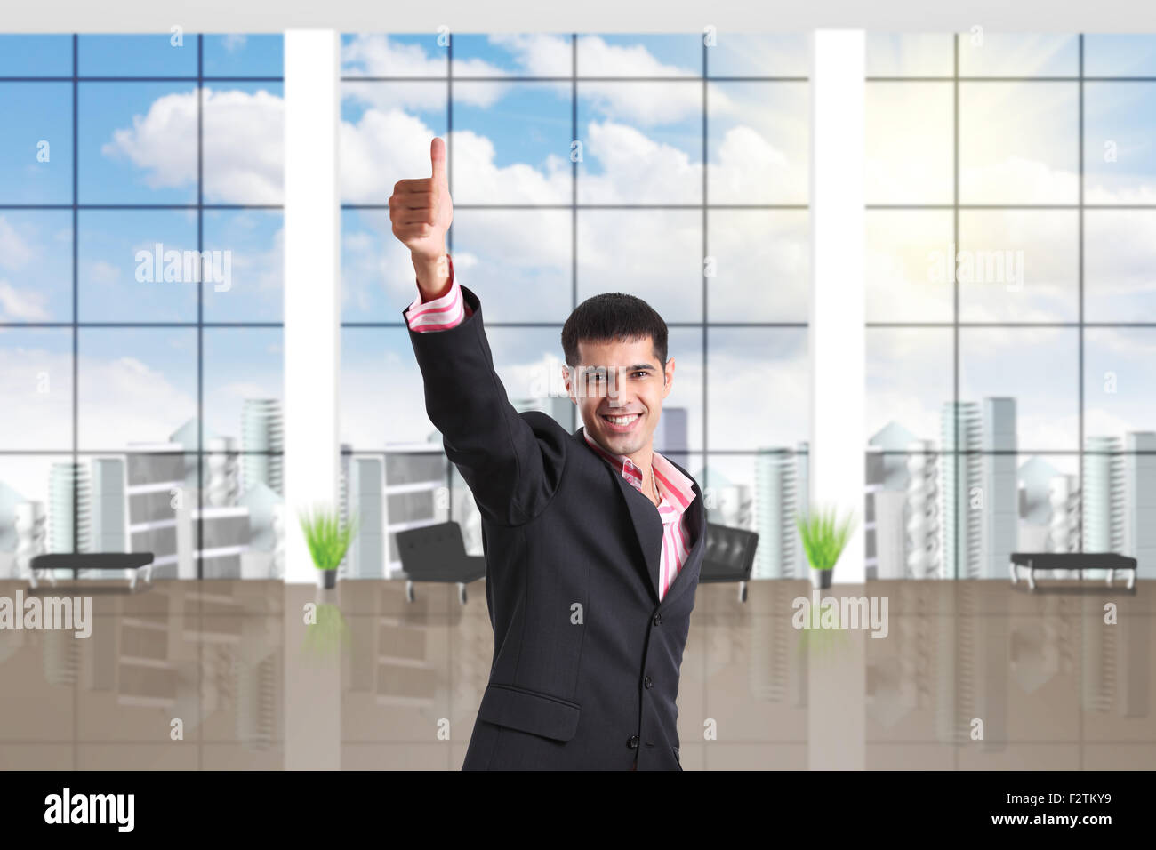 Happy businessman shows thumbs up sign Stock Photo