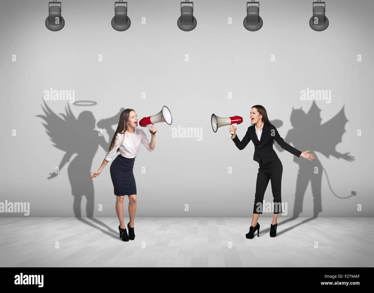 Businesswomen stands with shadow on the wall Stock Photo