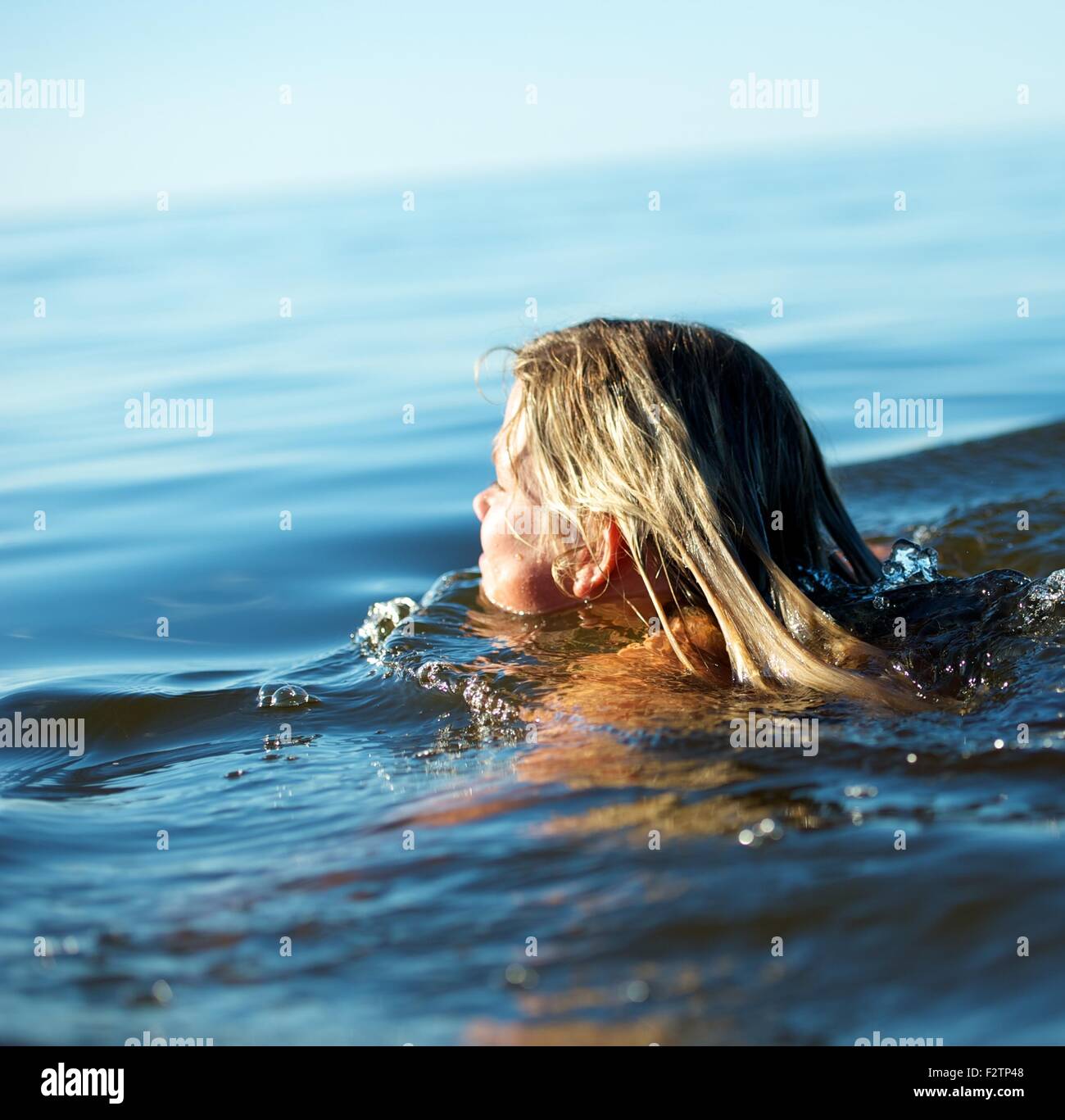 Girl swimming in the water Stock Photo