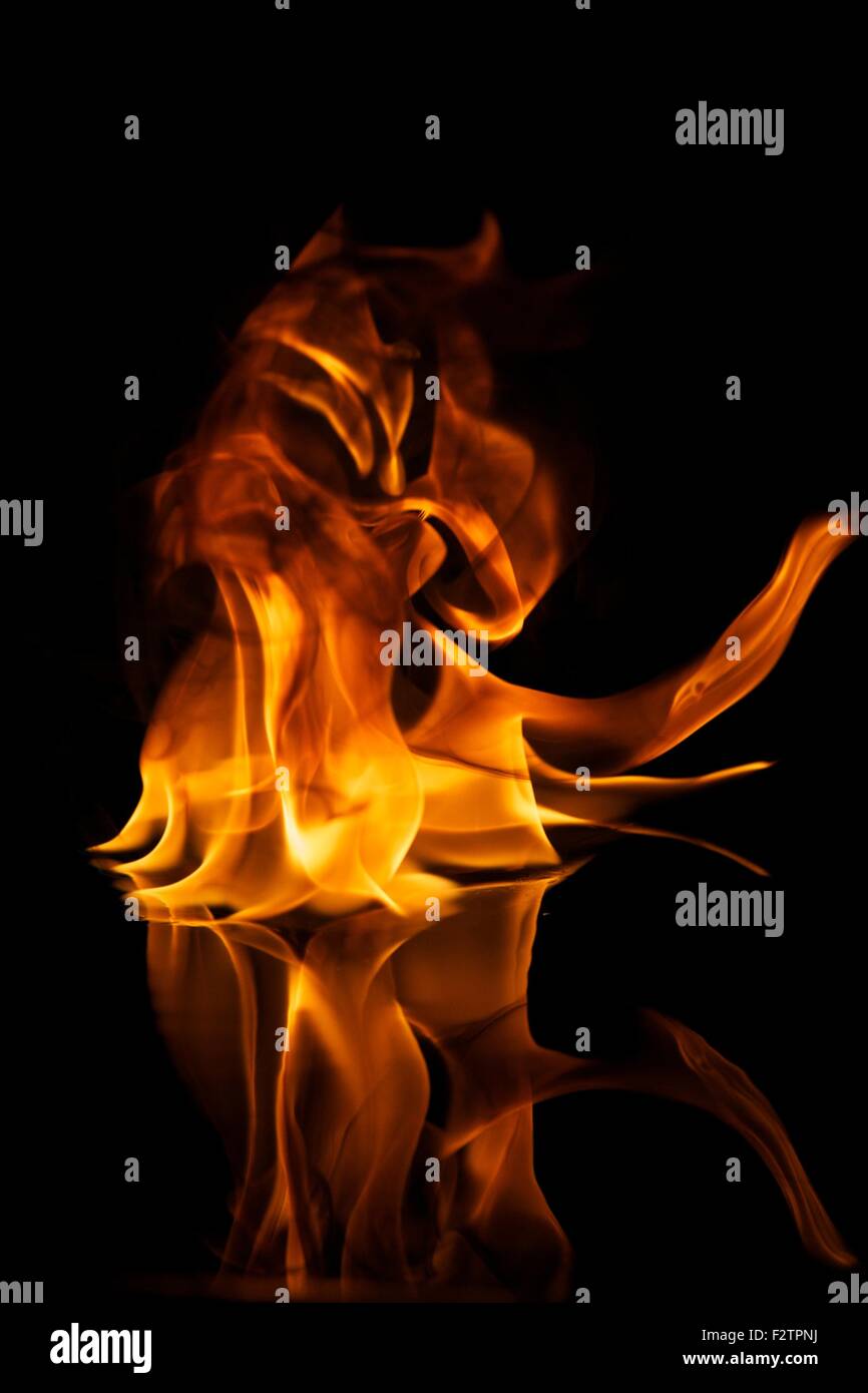 Fire flames reflected in water Stock Photo - Alamy
