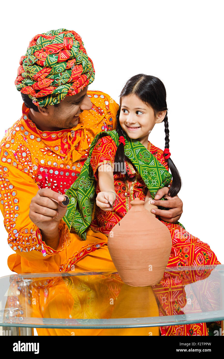 2 indian Rajasthani Villager father and daughter Piggy Bank Saving money Stock Photo