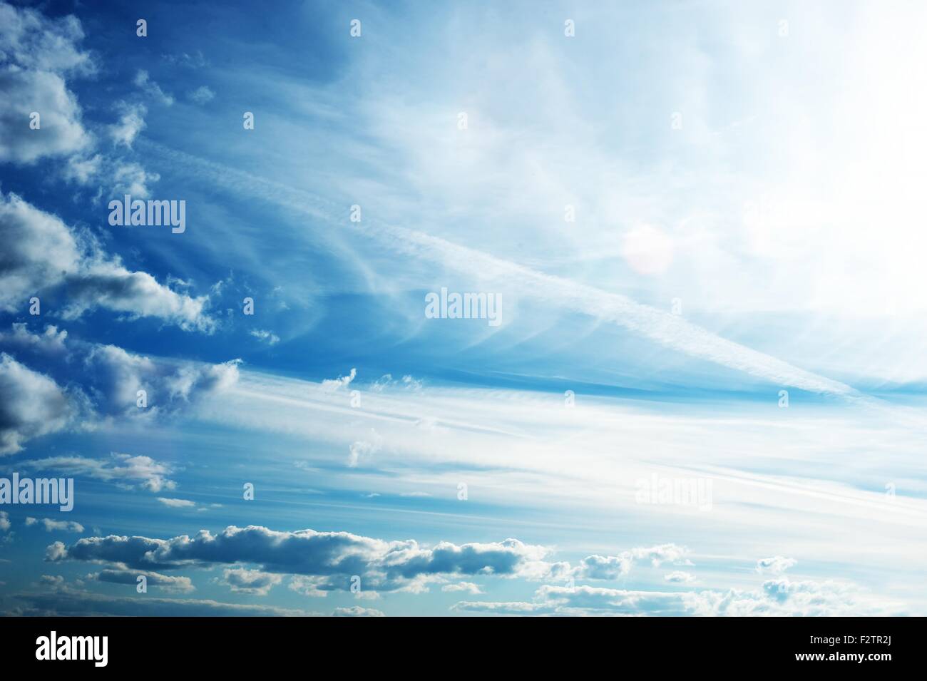 Blue sky with fluffy clouds Stock Photo - Alamy