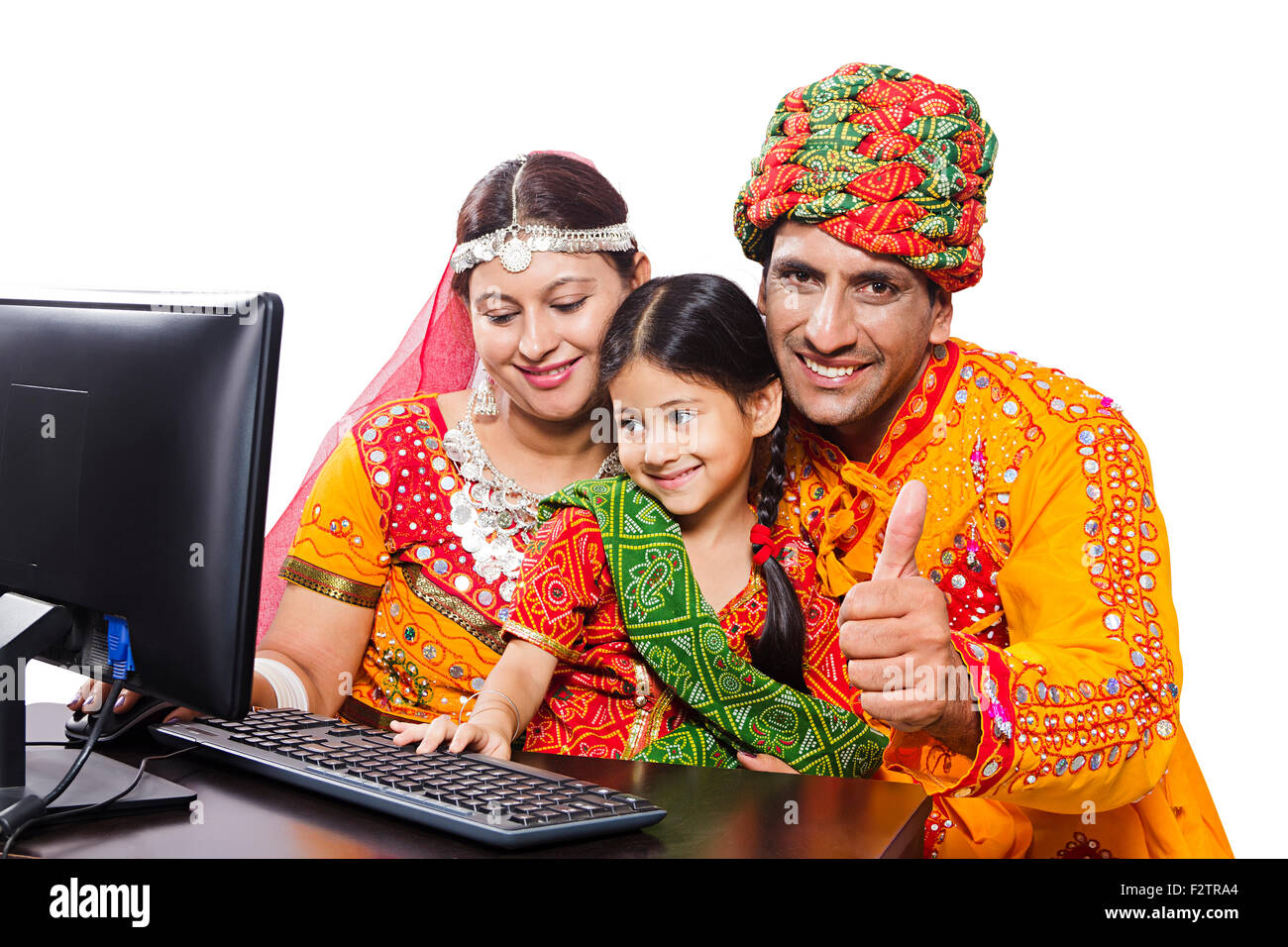 3 indian Rajasthani Villager Parents and daughter Computer Education and Thumbs Up showing Stock Photo