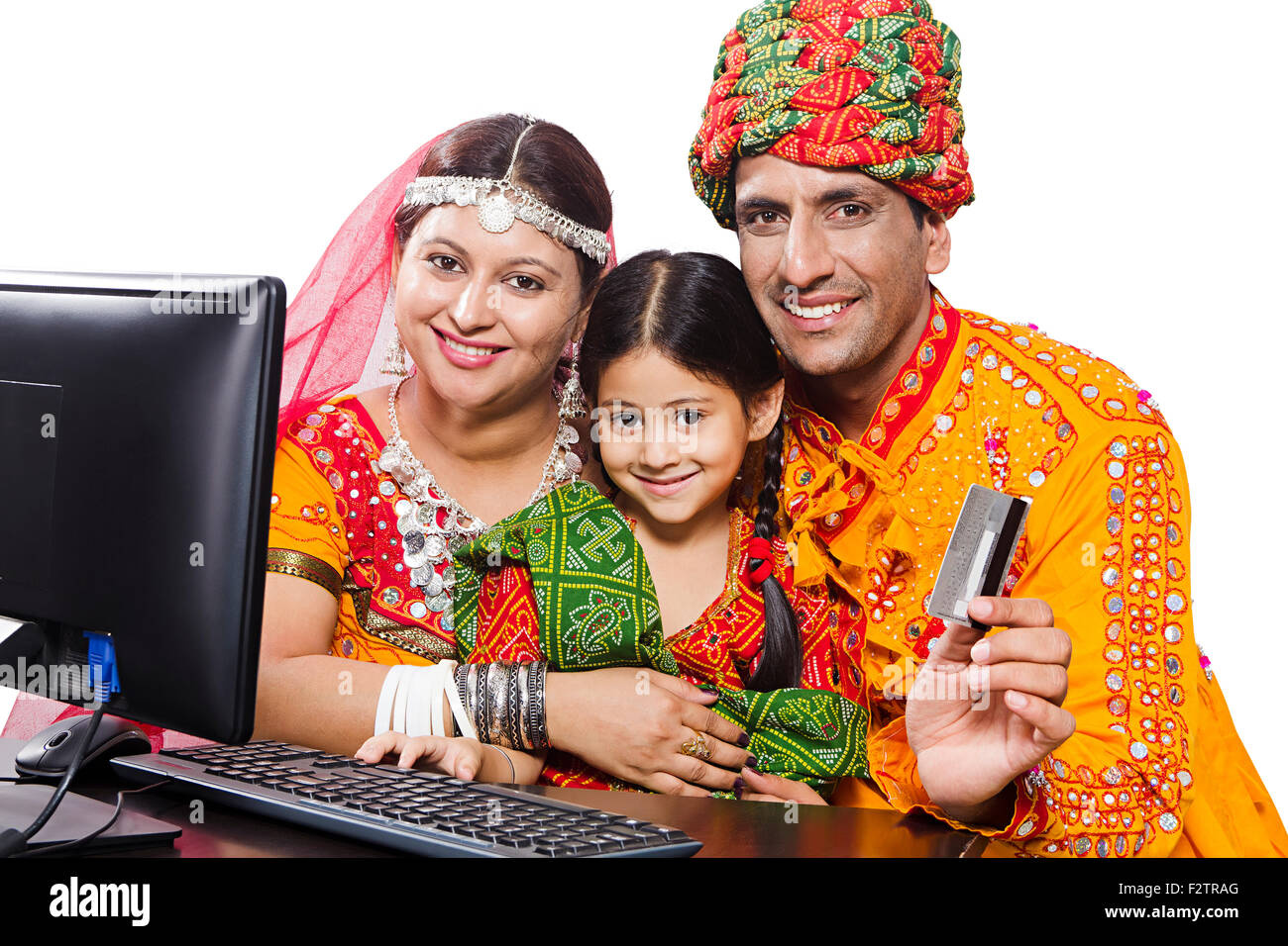 3 indian Rajasthani Villager Parents and daughter computer Credit Card online shopping Stock Photo