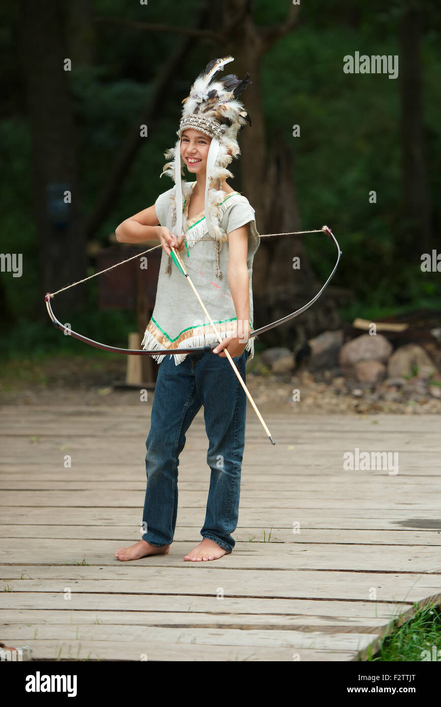 funny boy with native american costume and weapon Stock Photo - Alamy