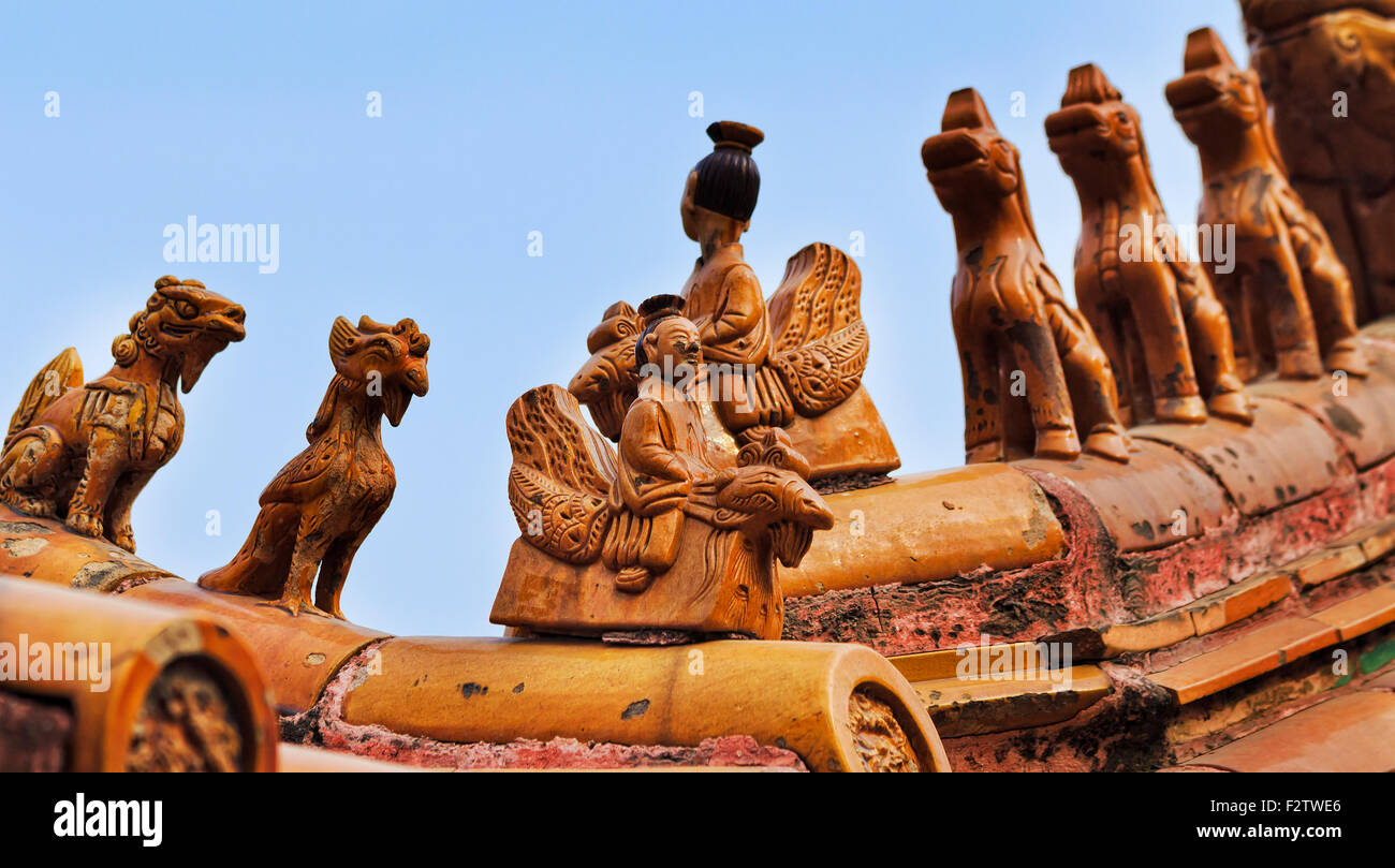 Arrangement of mystical spiritual protective figurines of gods at the roof top of Chinese emperor's forbidden palace in Beijing Stock Photo