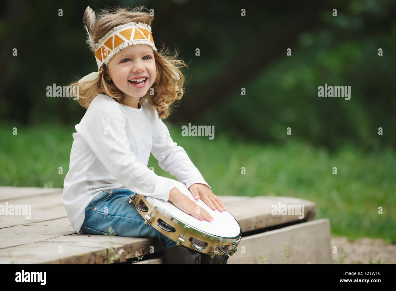 little Indian girl plays the tambourine Stock Photo Alamy