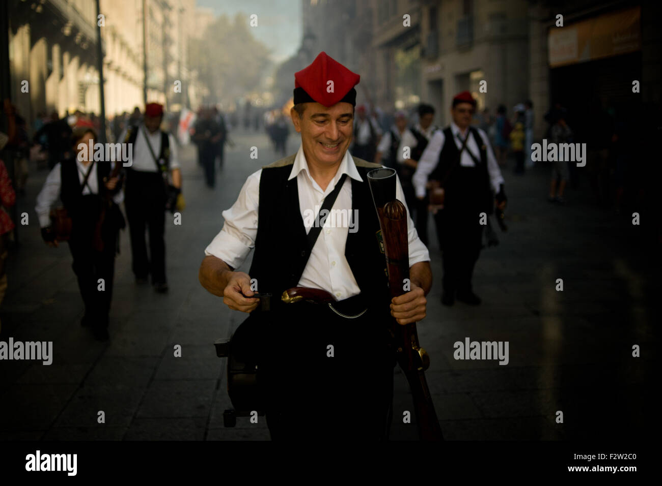 Barcelona, Catalonia, Spain. 24th Sep, 2015. A trabucaire through the streets of Barcelona on the occasion of the celebrations of the Merce Festival (Festes de la Merce) on 24 September 2015, Spain. The Galejada Trabucairemarks the beginning of the day of the patron saint of Barcelona, La Merce. Men and women dressed as ancient Catalan bandits take to the streets of the old part of Barcelona and cause a loud noise with his blunderbusses full of gunpowder. © Jordi Boixareu/ZUMA Wire/Alamy Live News Stock Photo