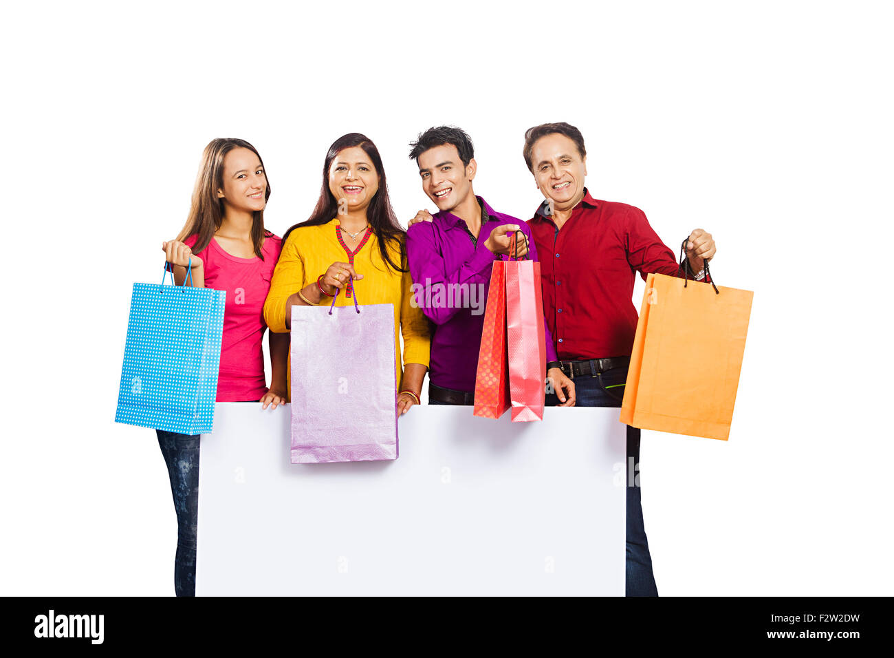 4 indian family Parents daughter and son Message Board with bag showing Stock Photo