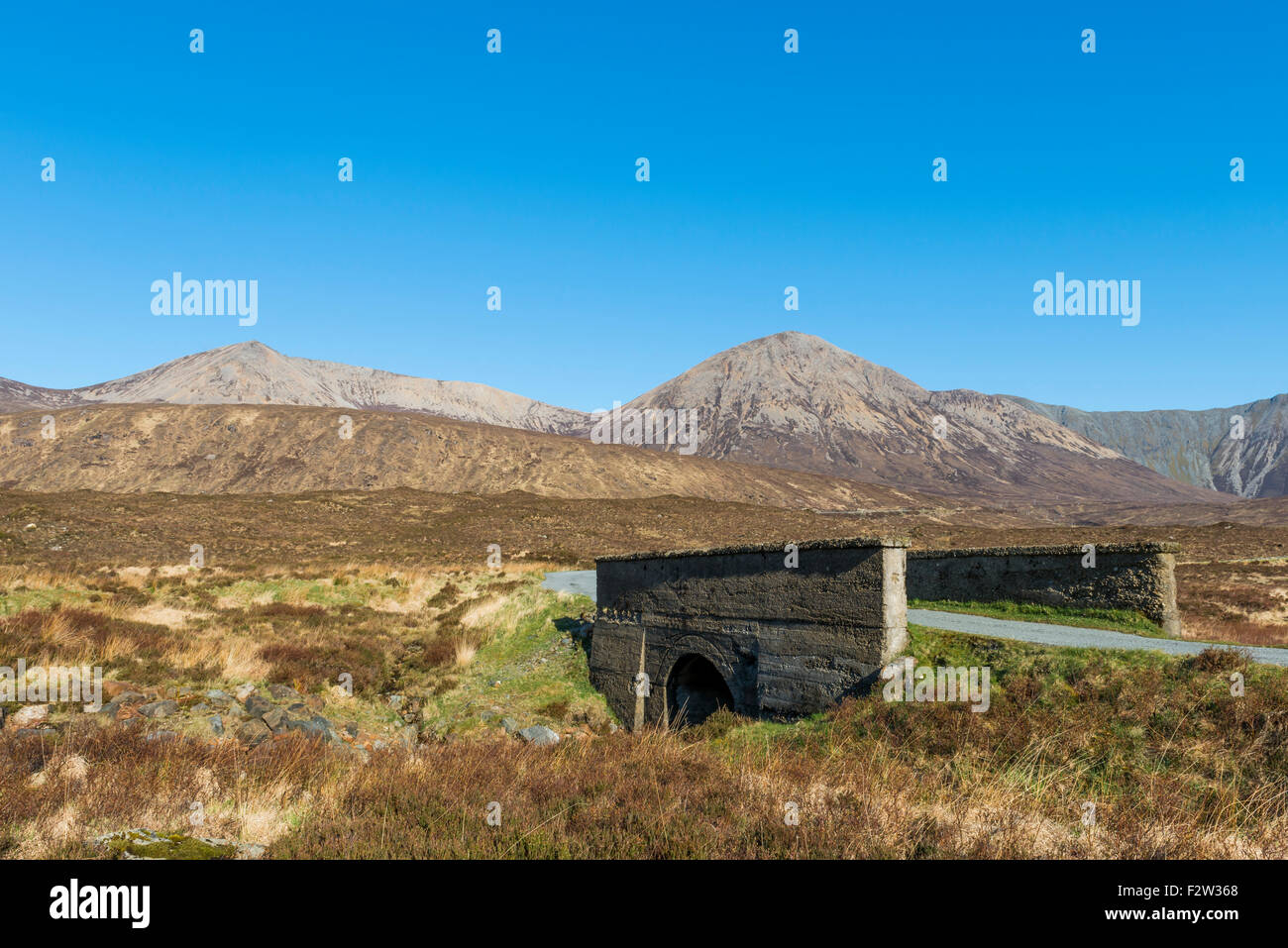 Bridge on the Isle of Skye with road and mountains in Scotland. Stock Photo