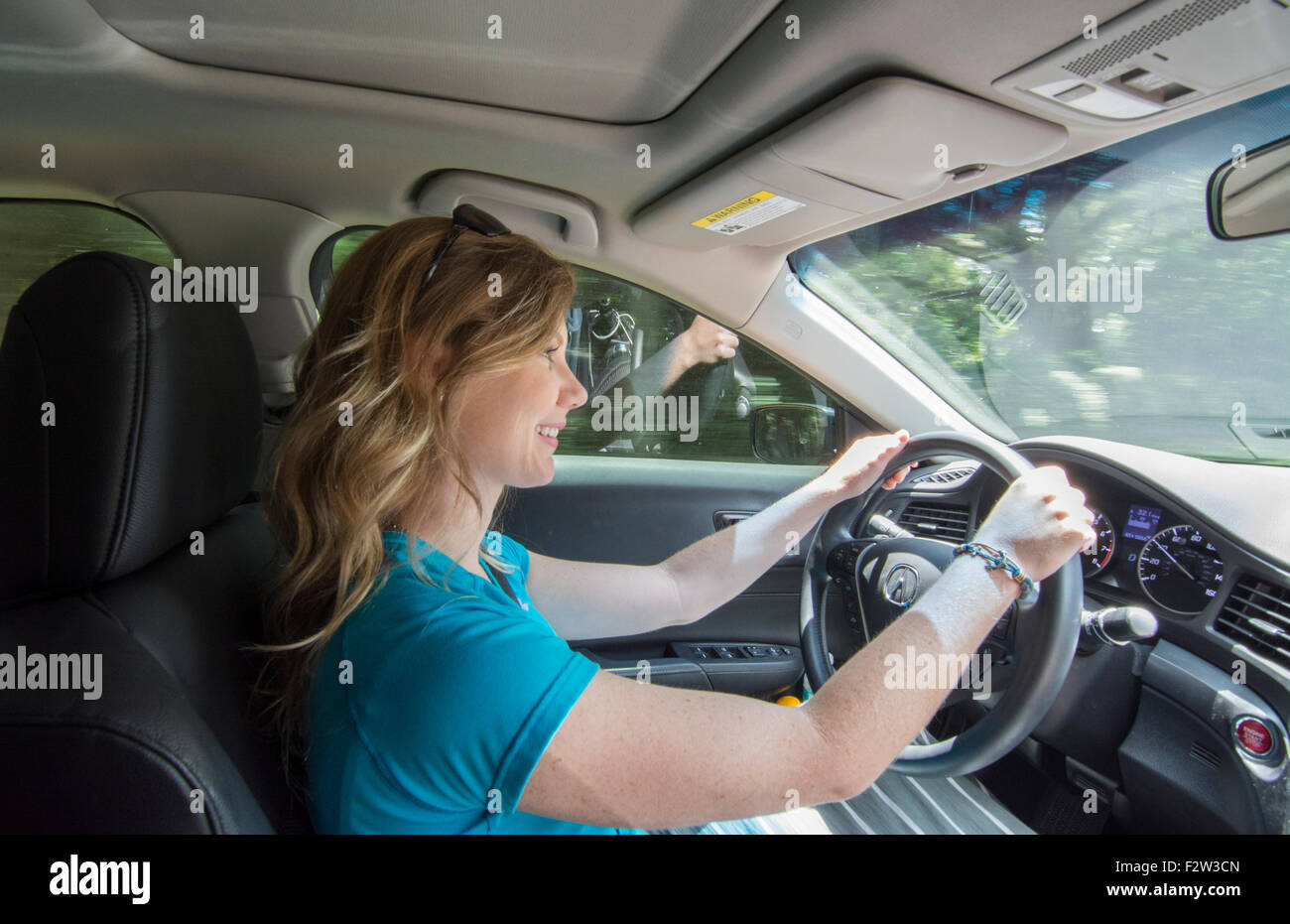 Young teenage girl age 16 with Dad in passenger seat as she drives car for the first time MR model released Stock Photo