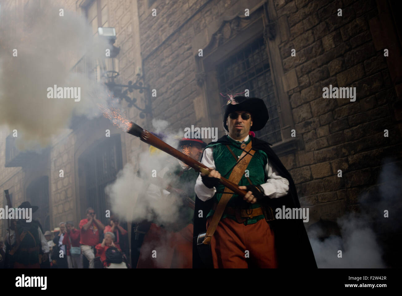 Barcelona, Catalonia, Spain. 24th Sep, 2015. A trabucaire shoots his blunderbuss through the streets of Barcelona on the occasion of the celebrations of the Merce Festival (Festes de la Merce) on 24 September 2015, Spain. The Galejada Trabucairemarks the beginning of the day of the patron saint of Barcelona, La Merce. Men and women dressed as ancient Catalan bandits take to the streets of the old part of Barcelona and cause a loud noise with his blunderbusses full of gunpowder. © Jordi Boixareu/ZUMA Wire/Alamy Live News Stock Photo