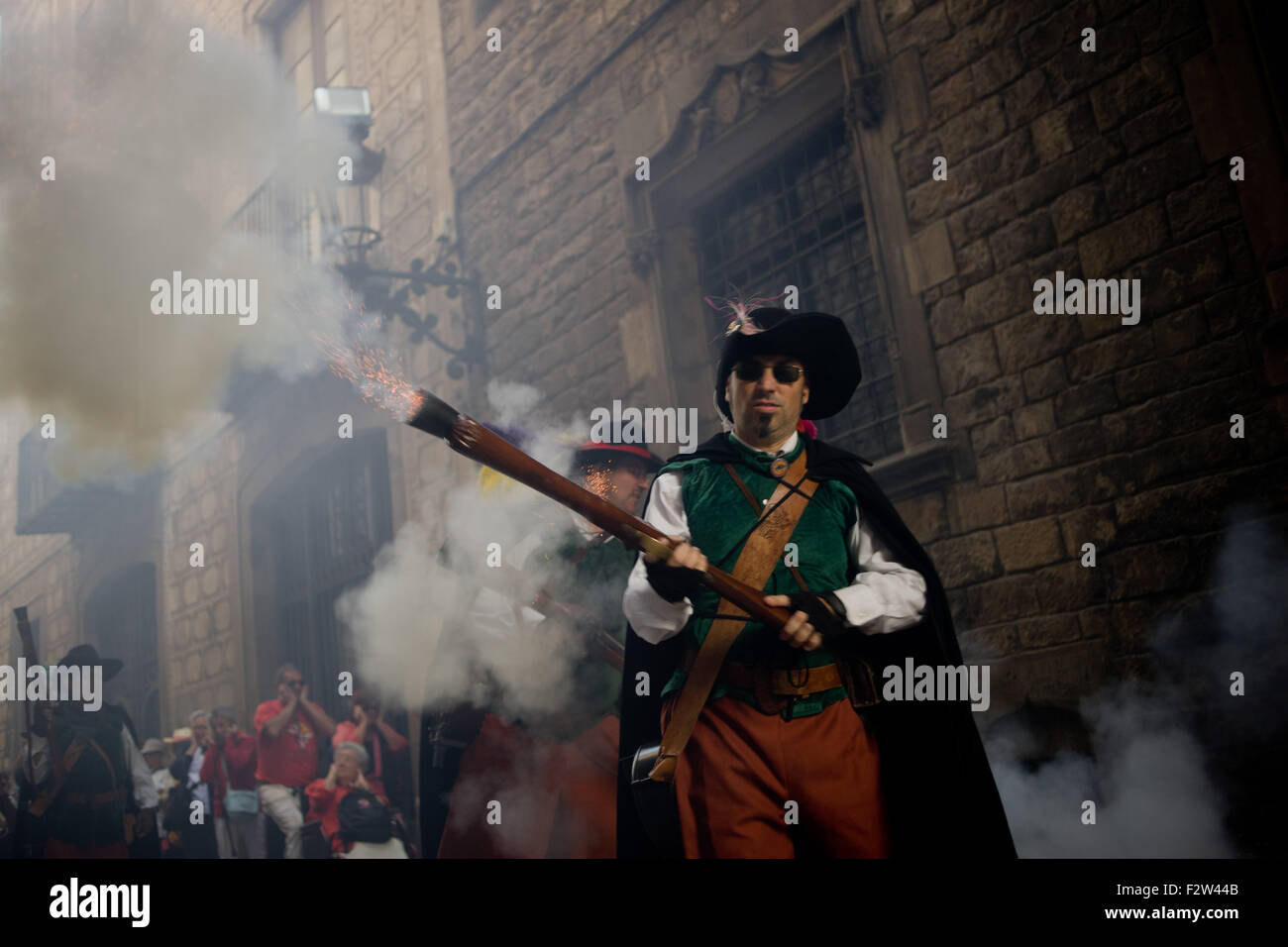 Barcelona, Spain. 24th September, 2015. A trabucaire shoots his blunderbuss through the streets of Barcelona on the occasion of the celebrations of the Merce Festival (Festes de la Merce) on 24 September 2015, Spain.  The Galejada Trabucaire marks the beginning of the day of the patron saint of Barcelona, La Merce. Men and women dressed as ancient Catalan bandits take to the streets of the old part of Barcelona and cause a loud noise with his blunderbusses full of gunpowder. Credit:   Jordi Boixareu/Alamy Live News Stock Photo