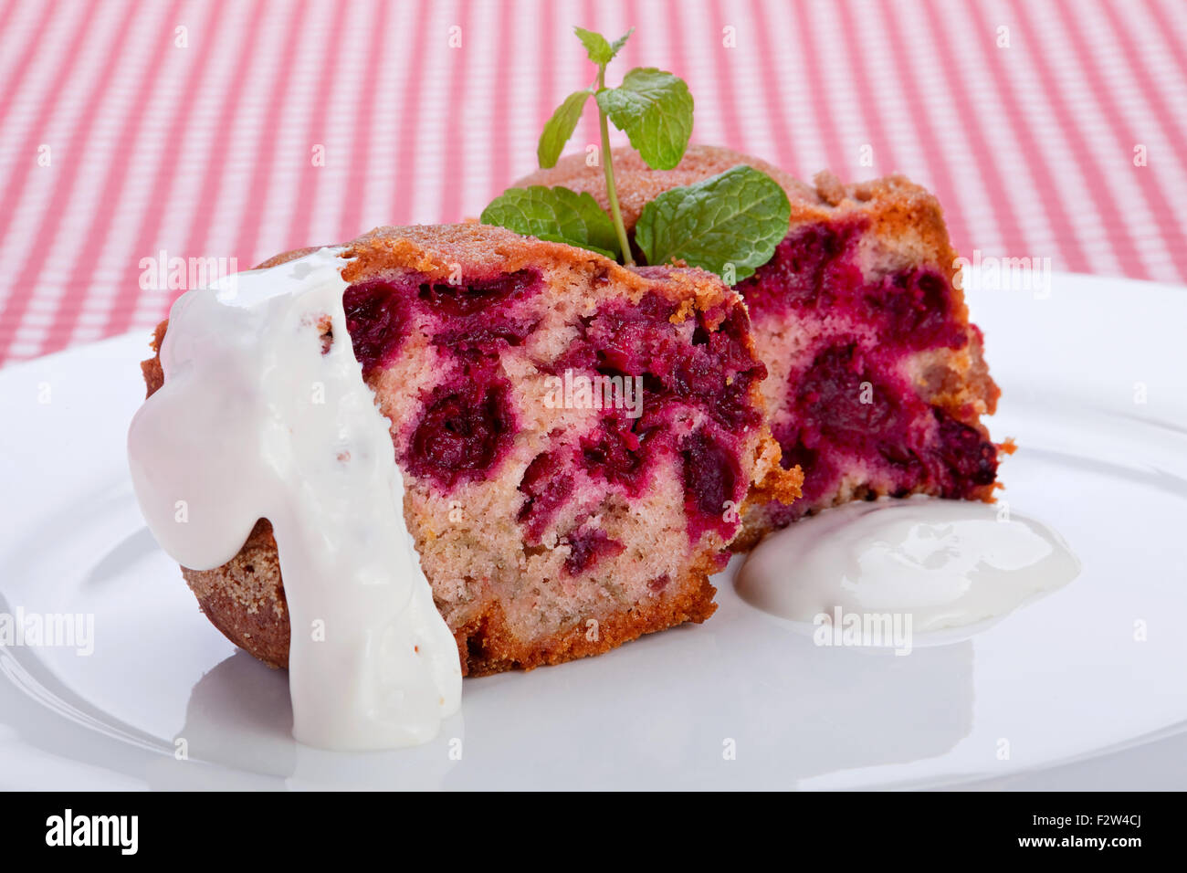 Cake with cherry and mint herb Stock Photo Alamy