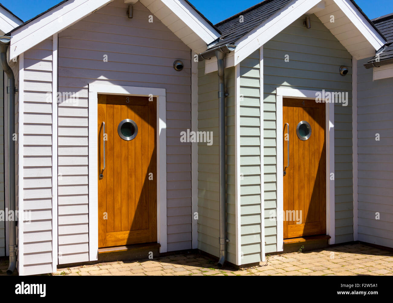 Wooden Doors - Front Entrances to Modern Beach Huts, Shaldon Devon. Stock Photo