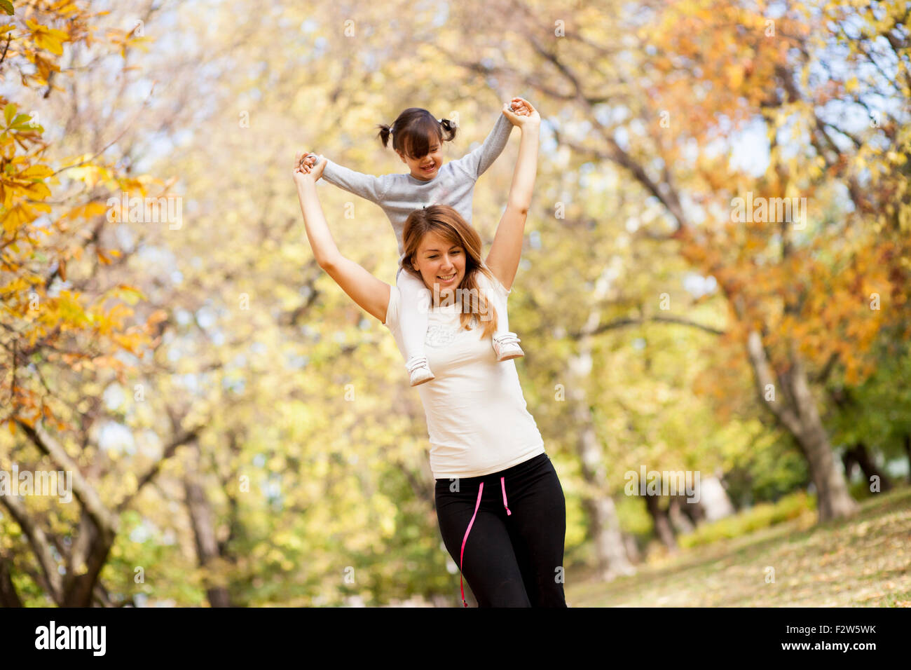 Mother an daughter in the autumn park Stock Photo - Alamy