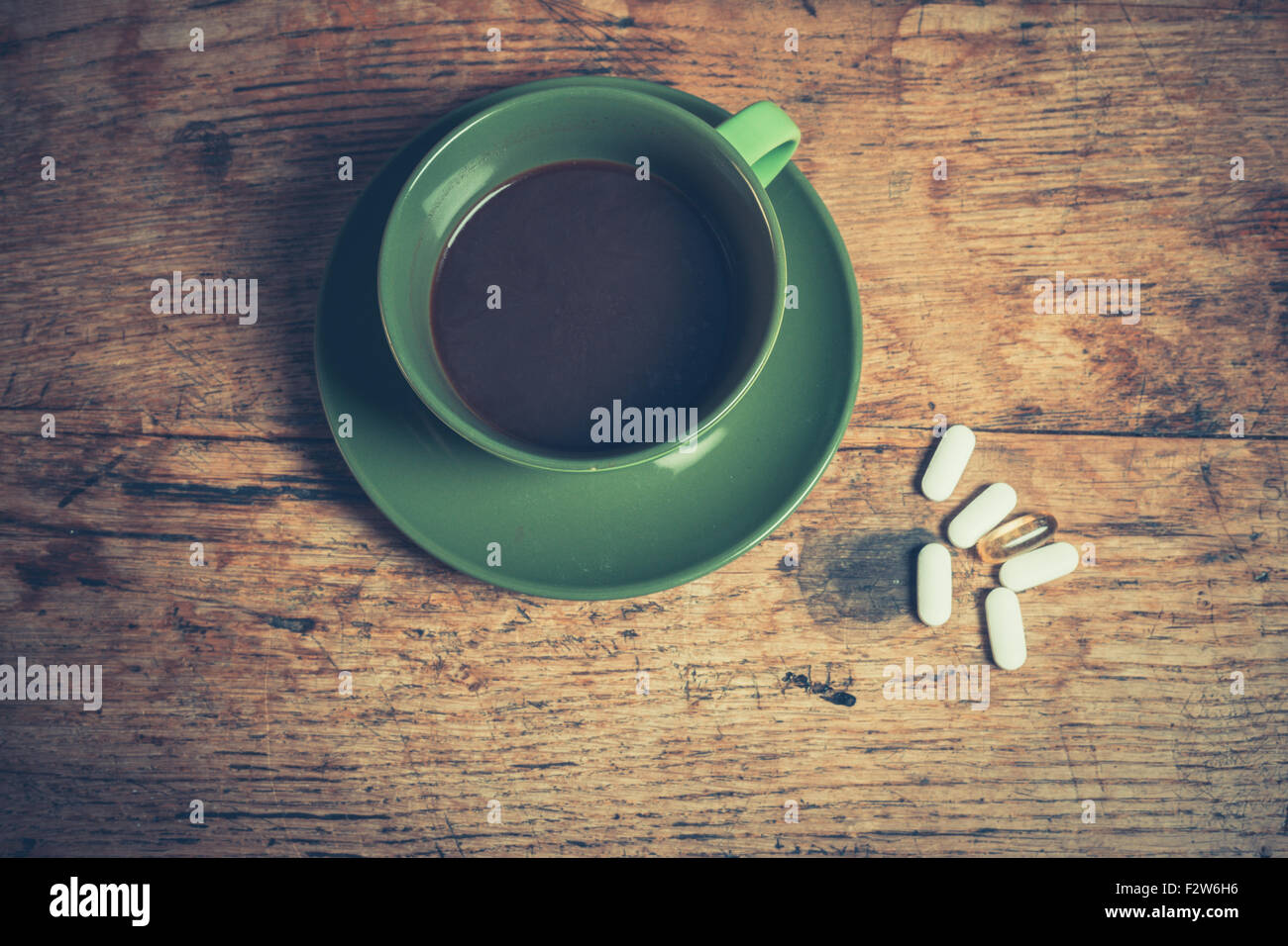 A cup of black coffee with six pills next to it Stock Photo Alamy