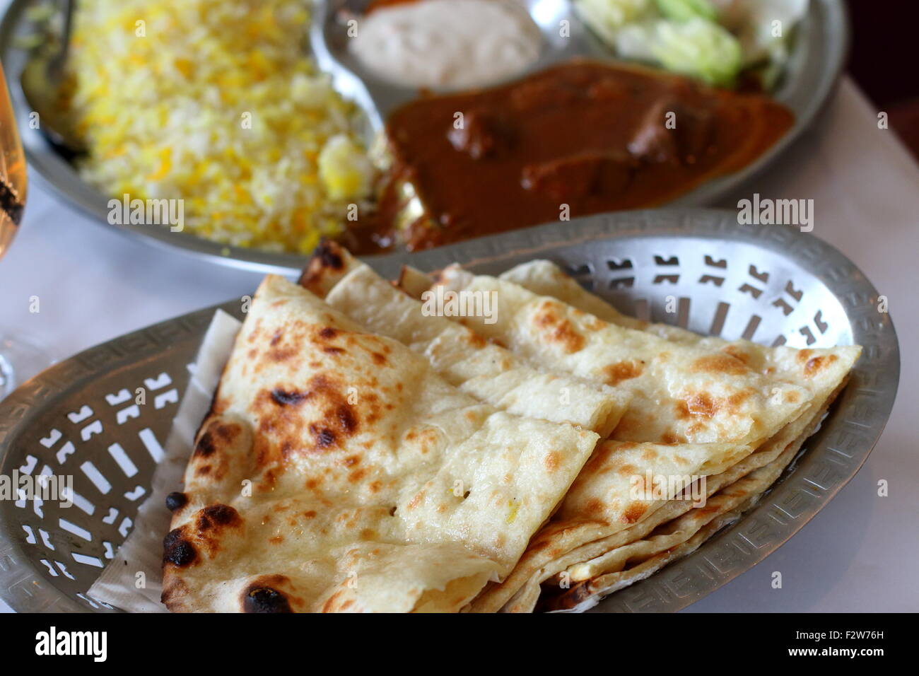 Close up of freshly made Naan bread in a bowl Stock Photo