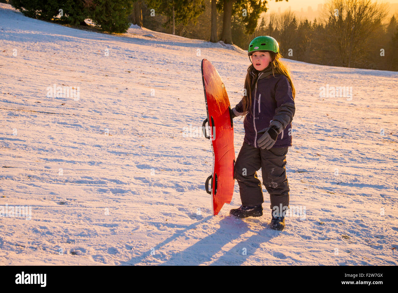 Boy with sled toboggan, Burnaby Mountain, Burnaby, British Columbia