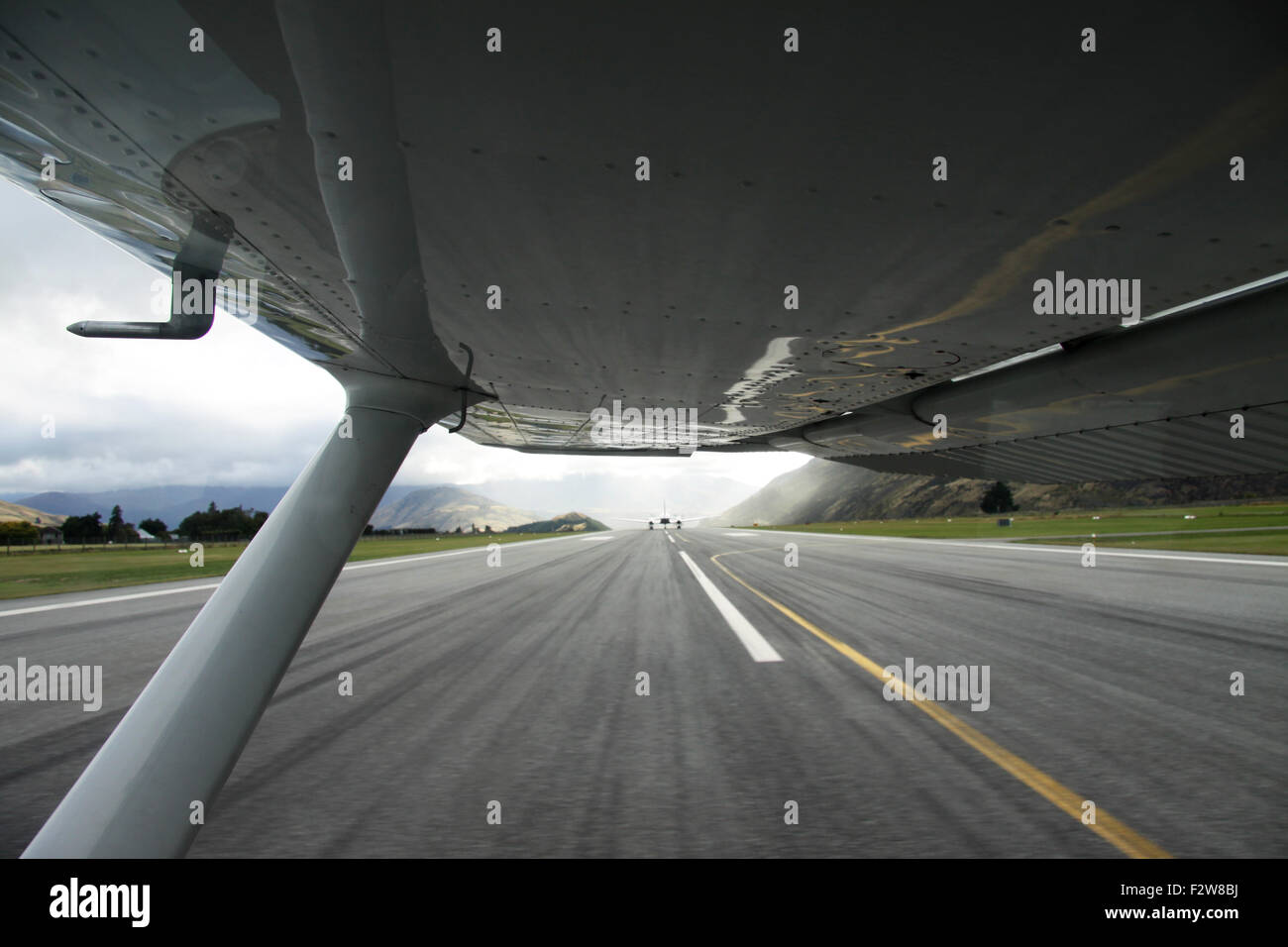 Under the wing of a small plane, taking off in Queenstown Airport, New Zealand. Stock Photo