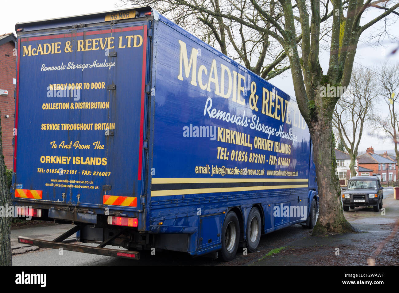 Orkney Islands based company, McAdie & Reeve Ltd storage, haulage and removals lorry parked in a narrow suburban street. Stock Photo