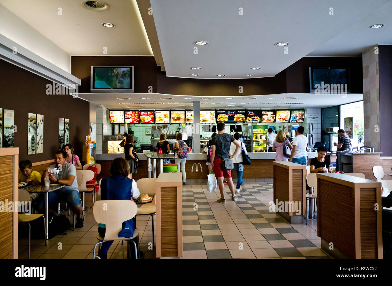 McDonalds restaurant interior with clients in queue and at the tables Stock Photo