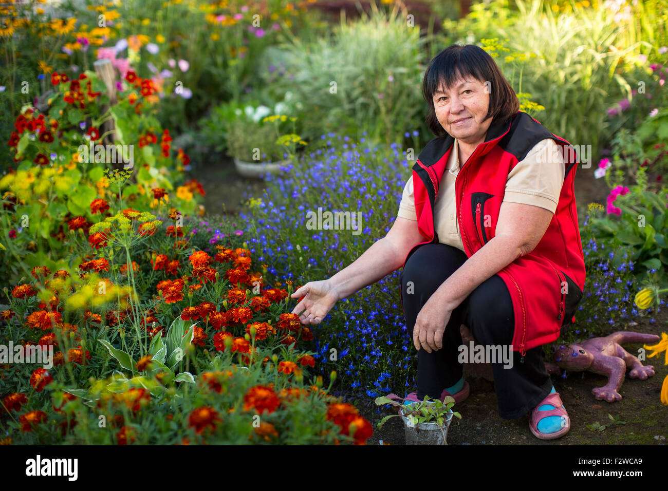 Mature woman in her garden. Stock Photo