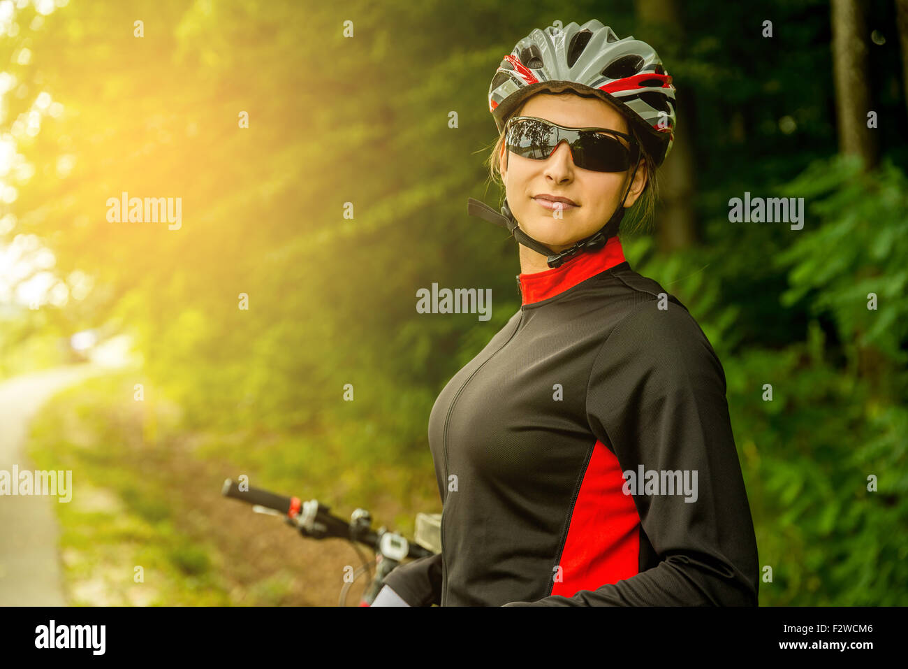 Happy Young Woman riding bicycle outside. Healthy Lifestyle. Stock Photo