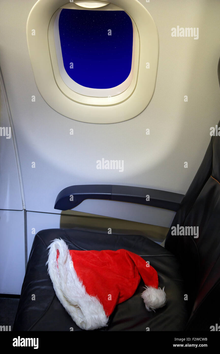 Santa Claus cap is an empty seat in a flying aircraft Stock Photo
