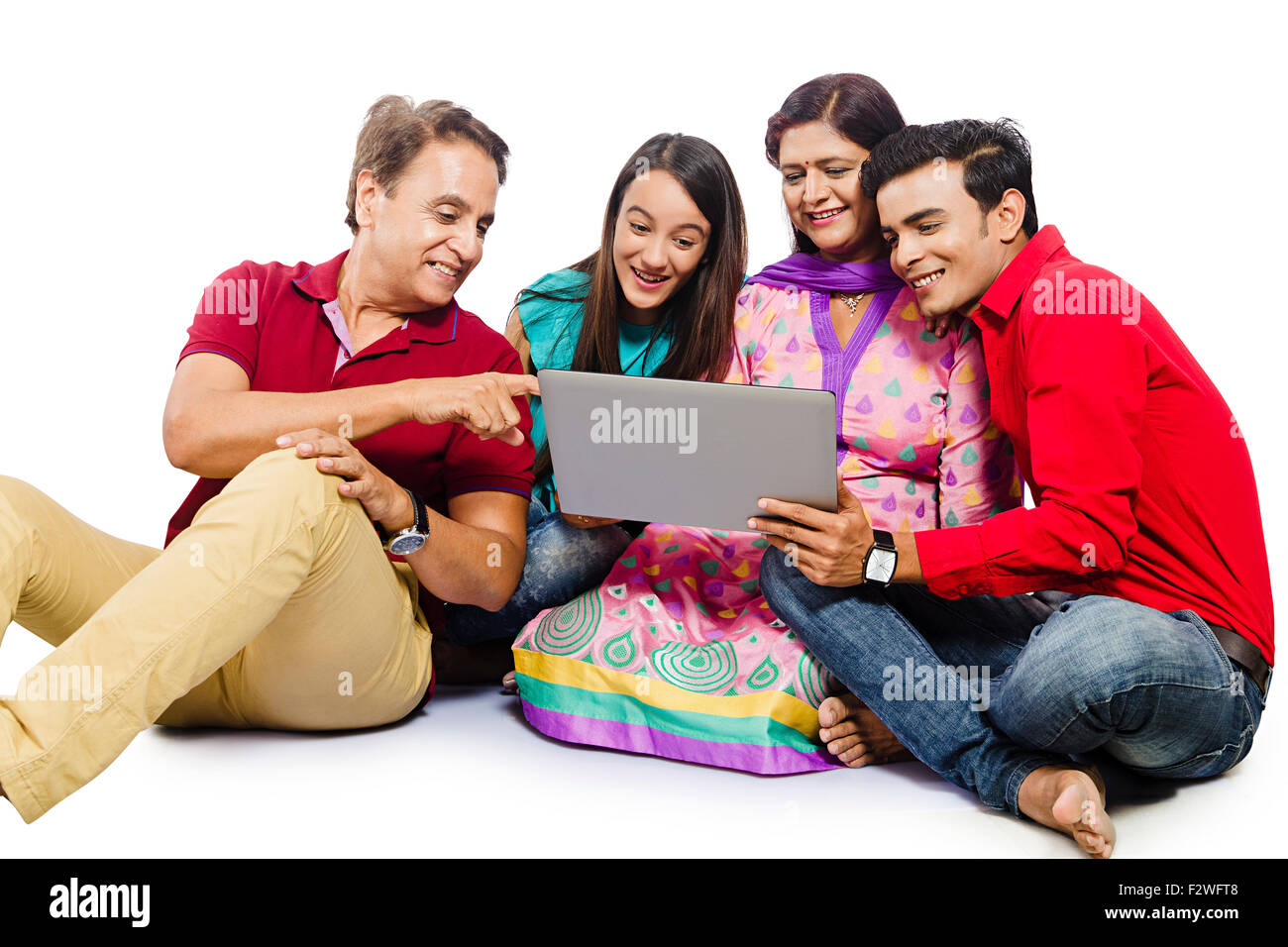 4 indian family Parents young daughter and son laptop Chatting Stock Photo