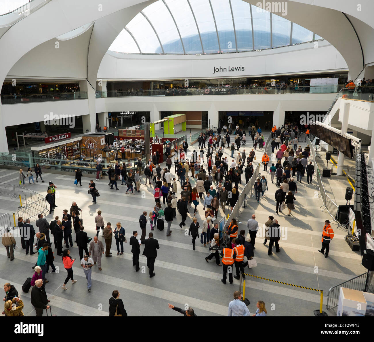 Rail travellers and shoppers inside the atrium at Birmingham Grand Central shopping centre above the newly renovated New Street station. Stock Photo