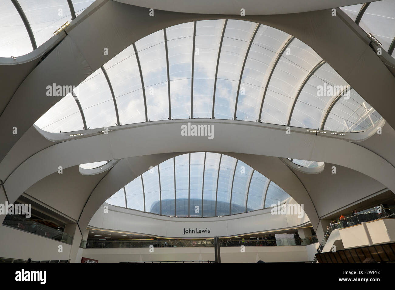 Inside the atrium at Birmingham's Grand Central shopping centre looking to John Lewis store, England, UK Stock Photo