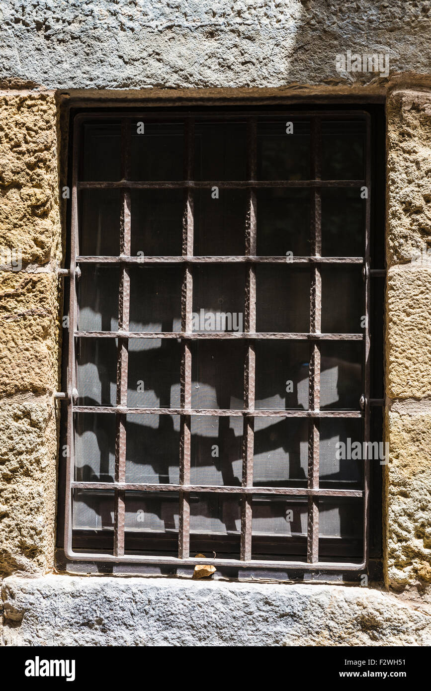 Old barred window in Pals, Girona, Catalonia, Spain Stock Photo