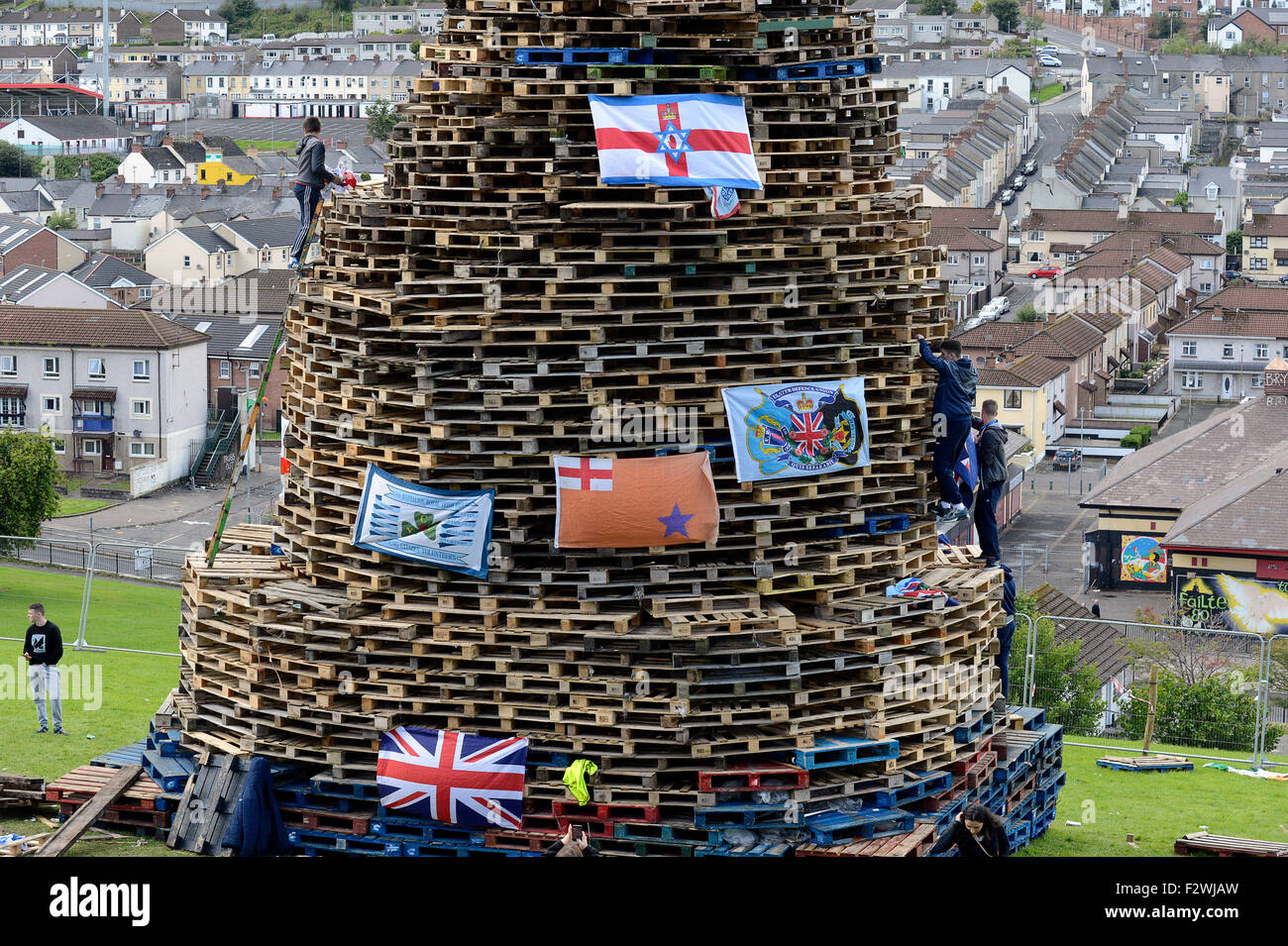 Nationalist youths standing on a large bonfire made from wooden pallets