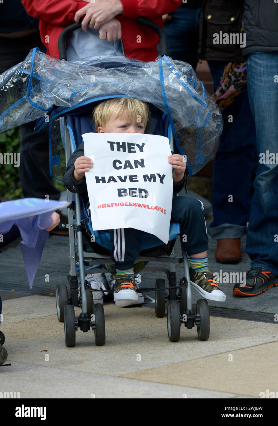 Little boy in pram with poster at a rally in Londonderry, Northern Ireland, in support of the refugee humanitarian crisis. Stock Photo