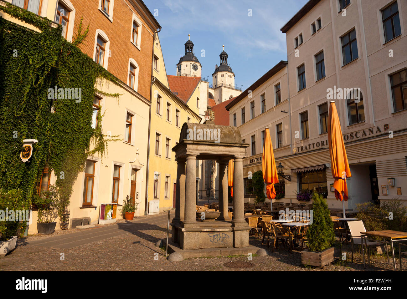 Historical water well at Holzmarkt 'wood market'  square and church Stadtkirche St. Marien, Lutherstadt Wittenberg, Saxony-Anhal Stock Photo