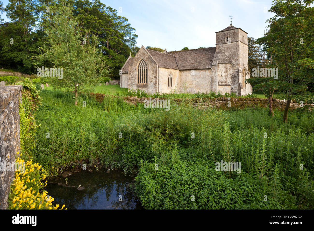The church of St Michael & St Martin beside the River Leach in the Cotswold village of Eastleach Martin, Gloucestershire UK Stock Photo
