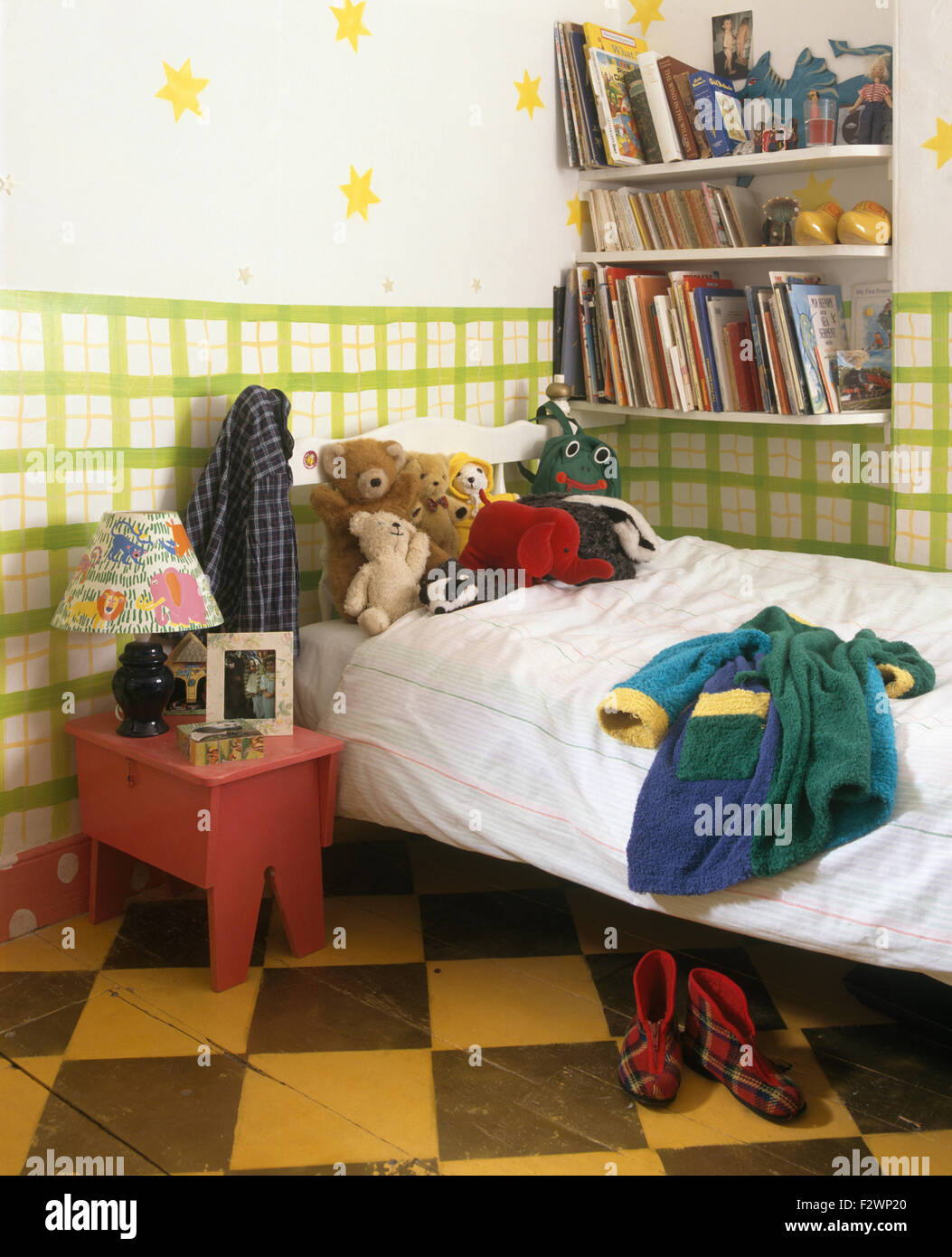 Hand painted green grid walls in child's economy bedroom with
