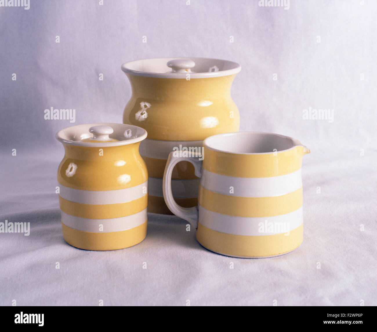 Closeup of yellow striped Cornishware jug and storage jars Stock Photo