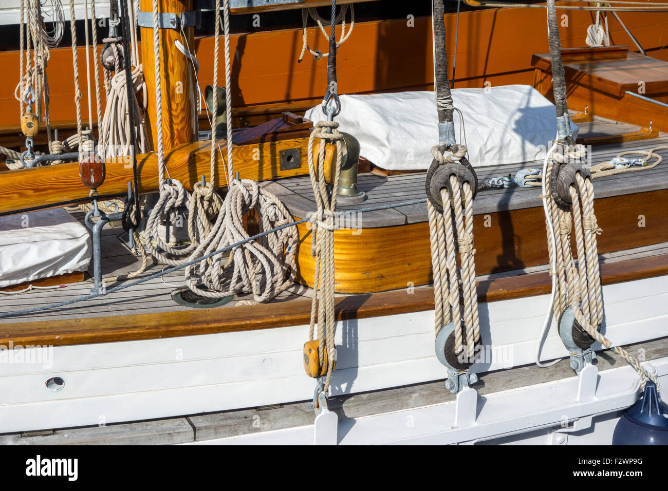 Deck, ropes, rigging and wooden pulleys / blocks on board of sailing