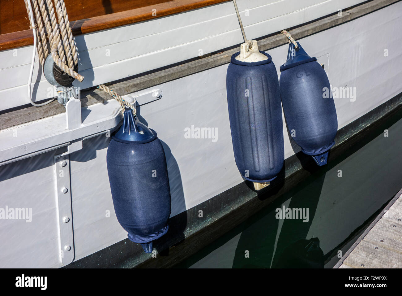 Fenders, used to prevent damage to sailing boat / vessel when berthing against jetty Stock Photo
