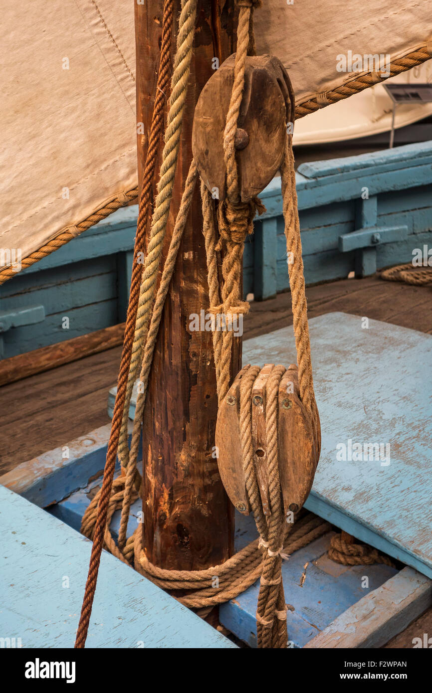 Rope in wooden pulleys / blocks on deck of sailing boat / fishing boat Stock Photo