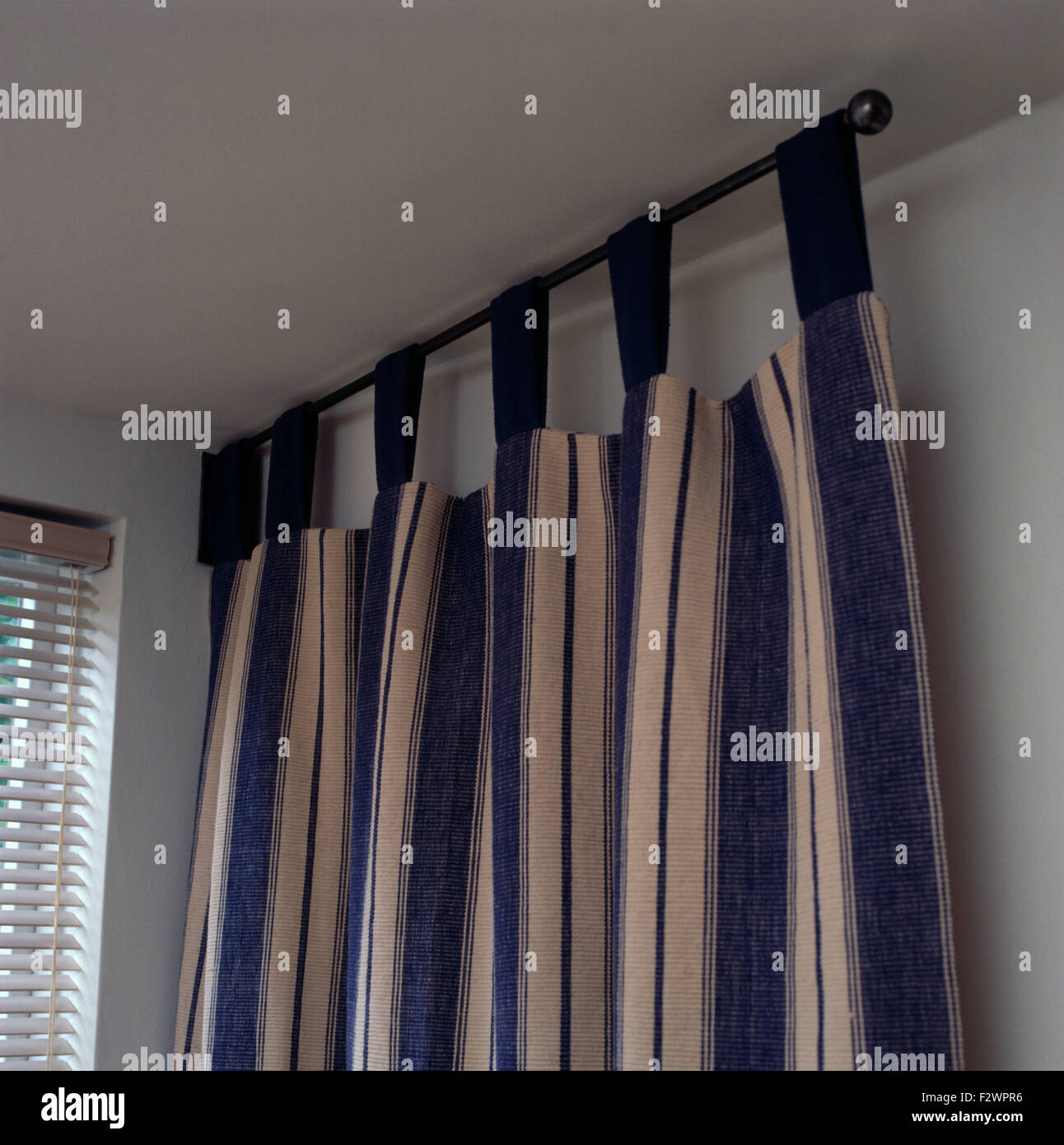 Close-up of blue+white striped tab curtains Stock Photo