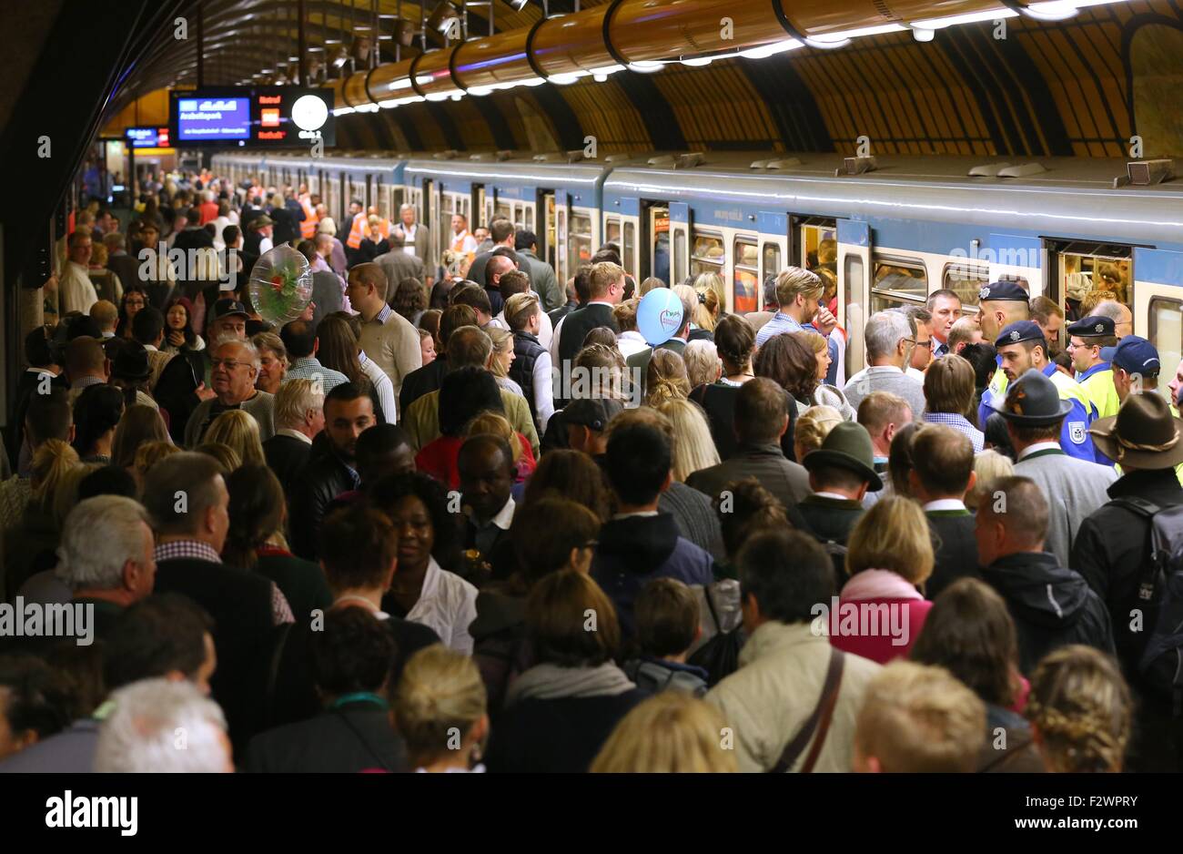 Munich, Germany. 20th Sep, 2015. Oktoberfest visitors attempt to board a subway train on a crowded platform of Theresienwiese subway station upon their departure in Munich, Germany, 20 September 2015. The world's largest beer festival which will run until 04 October 2015 is expected to attract some six million visitors from all over the world this year. Photo: KARL-JOSEF HILDENBRAND/dpa/Alamy Live News Stock Photo